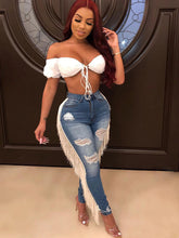 Vaqueros ajustados con cremallera y borlas rasgadas de Danim